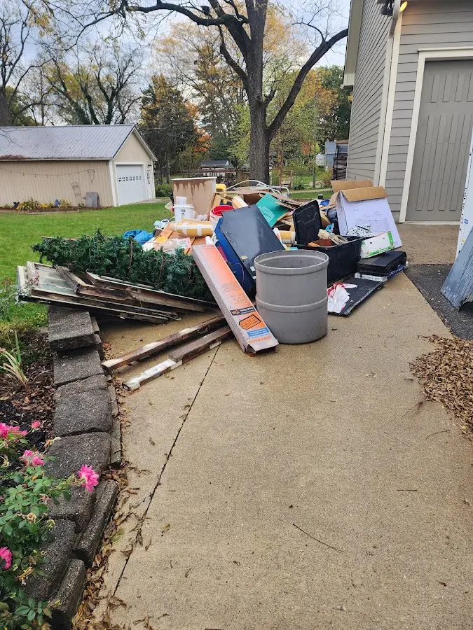 Dumpster being loaded with debris for 12 Yard Dumpster Rental in Eagar